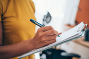 Woman making notes on a clipboard