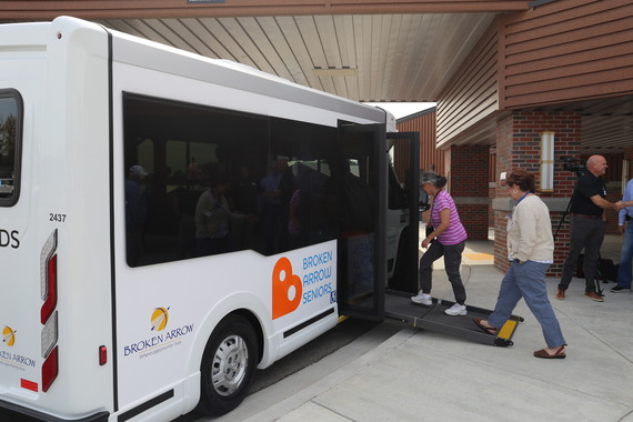 Broken Arrow Senior Center members step onto the new van for the first time. 