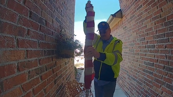 David Heard is rolling up the flag. 