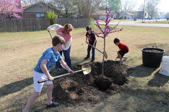 Councilor Lisa Ford and students from Peters Elementary school plant a Redbud Tree at Country Aire Park in celebration of Arbor Day.