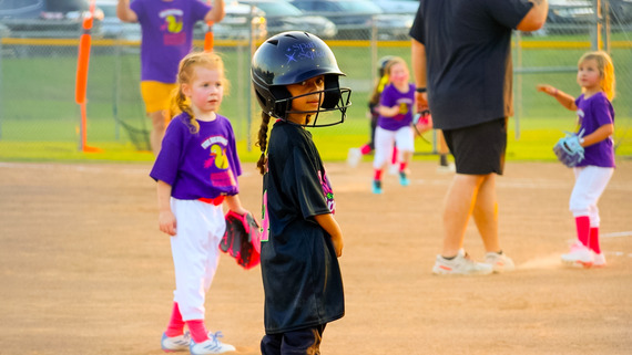 Girls softball athlete smiling at the camera