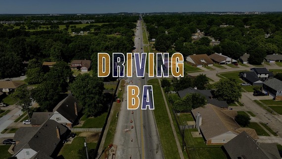 Graphic of DRIVING BA over the top of aerial shot of Houston Street between Olive and Aspen avenues