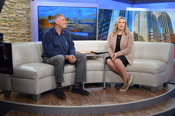 A man and woman sitting on a couch.