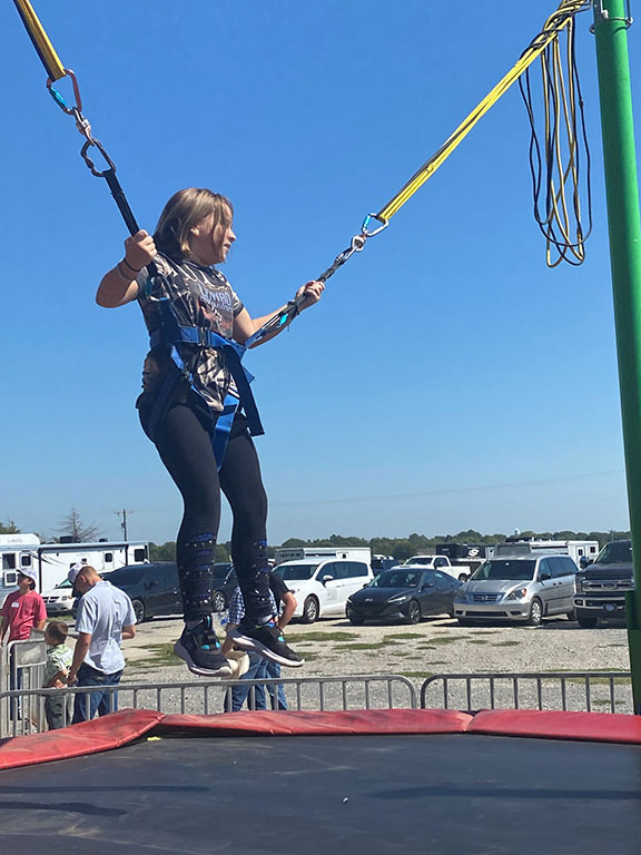 Girl on a bungie cord machine.