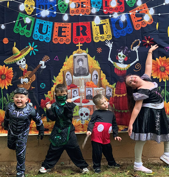 Three kids in Halloween costumes.
