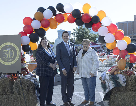 Two women and a man.