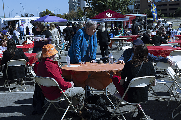 Group of people talking around table. 