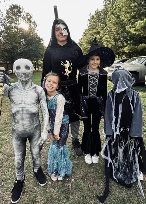 Five youths in Halloween costumes.