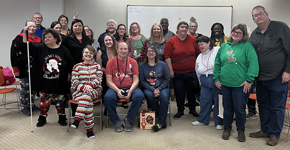 Group of people smiling for photo. 