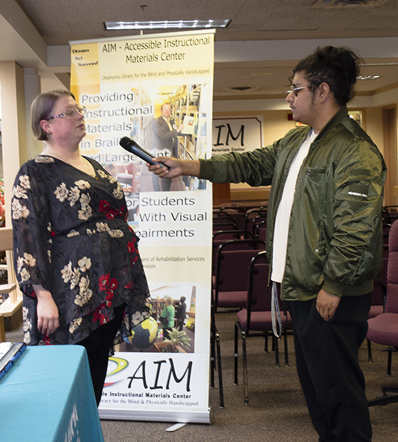 Man interviewing woman.