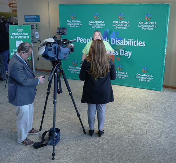 Television crew interviewing woman.