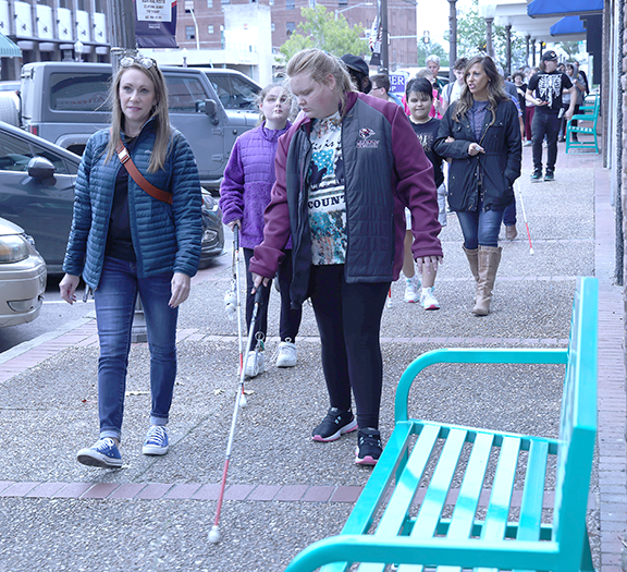 People walking with white canes.