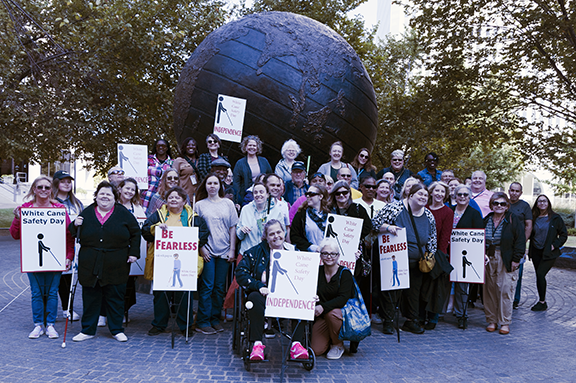 Group of people with some holding signs.