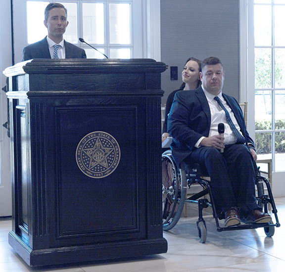 Man speaking at podium.