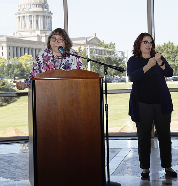 Woman speaking at ADA celebration.