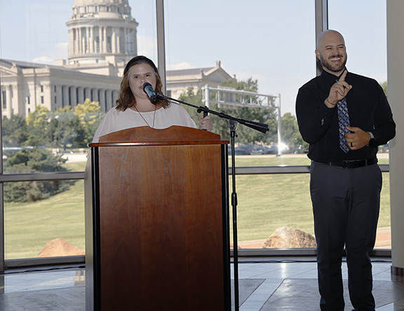 Woman speaking to a crowd.