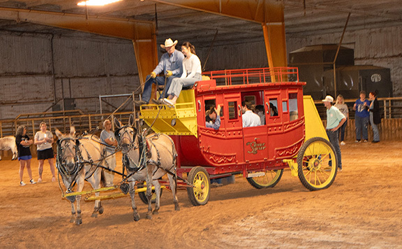 Stagecoach with drivers and students inside.