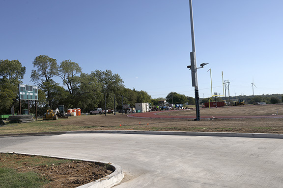 Scoreboard and building materials at OSB football field.