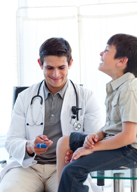 Male doctor gives boy wellness checkup