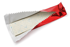 Opened stick of chewing gum in red foil wrapper