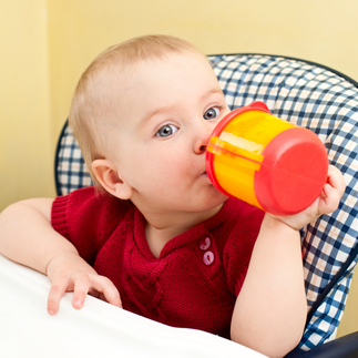 child holding sippy cups