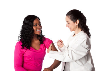 Doctor injects vaccination in female patient