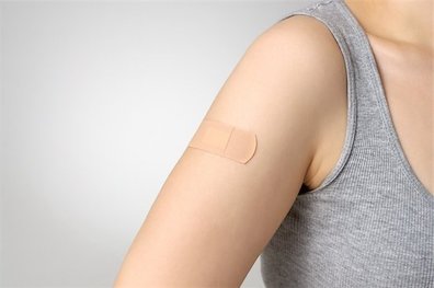 girl with a bandaid on her arm