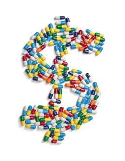 The dollar symbol made out of colorful pills isolated on white background.