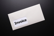 Business envelope with the word "Invoice" showing through window.