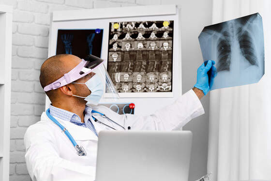 Photo of doctor examining a lung X-ray