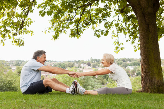 Photo of mature couple outside stretching