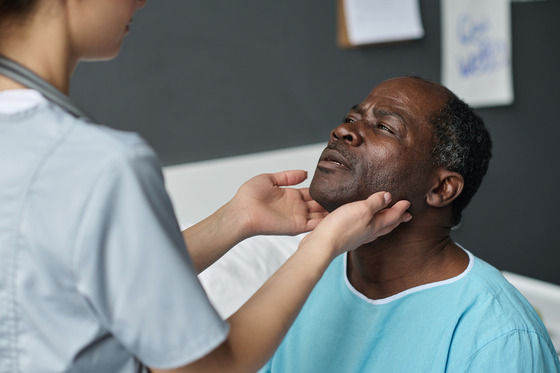 Photo of doctor examining male patient