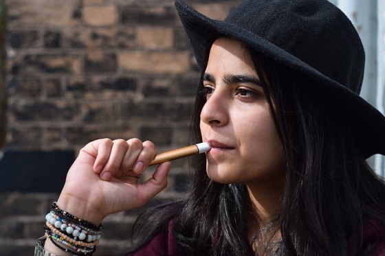 Photo of young girl smoking an e-cigarette