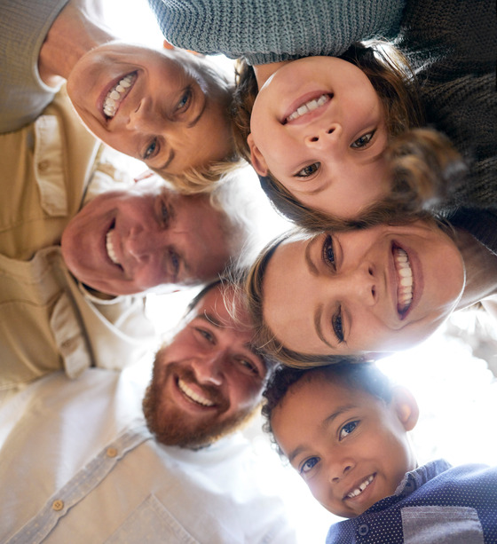 Photo of family looking down into camera