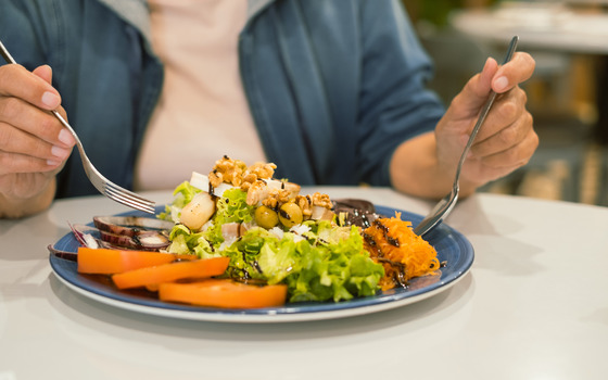 Photo of a woman with a healthy plate of food