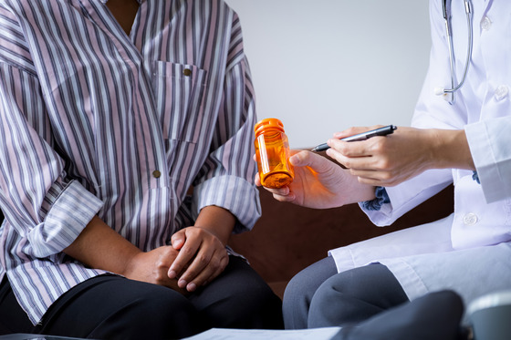 Photo of a doctor explaining a medication to a patient