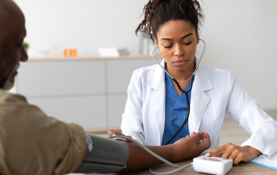 Photo of a doctor taking a patient's blood pressure