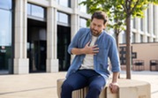 Photo of a man experiencing heartburn