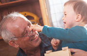 Photo of a grandfather enjoying his grandson