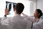 Photo of doctors conferring on a lung X-ray