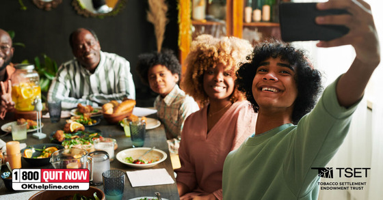 TSET graphic with a family sitting down for a holiday dinner and one family member is taking a photo of the group