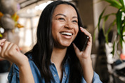 Photo of a smiling woman on the phone