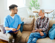 Photo of a health care worker visiting a patient in their home