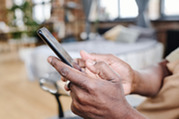 Photo of a person typing on a mobile phone