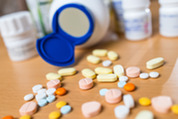 Photo of various pill bottles and pills on a table