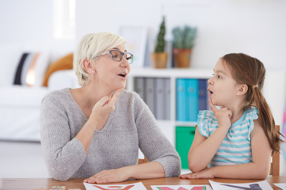 Photo of a woman and child practicing speech