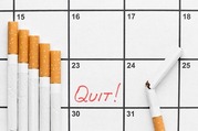 Photo of a pack of cigarettes on a calendar with the word "quit" circled on a day