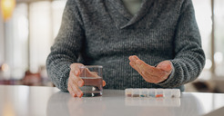 Photo of a senior man taking medication