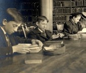 children reading around a library table