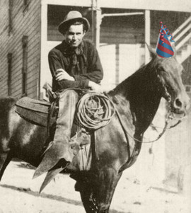 Will Rogers on a horse with a birthday hat